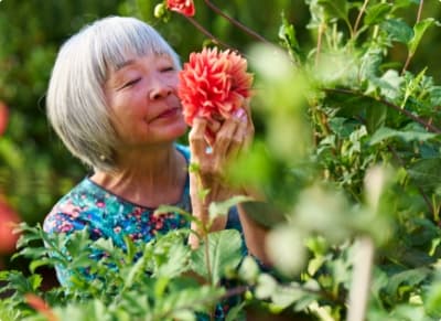 Senior woman smelling a flower