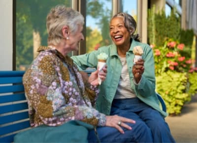 Two senior women eating ice cream