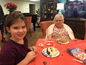 Girl Scouts Decorate Gingerbread Houses with Canfield Place Residents