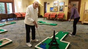 Resident playing miniature golf at Fairwinds - Redmond