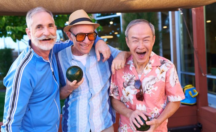 Three senior men playing bocce ball