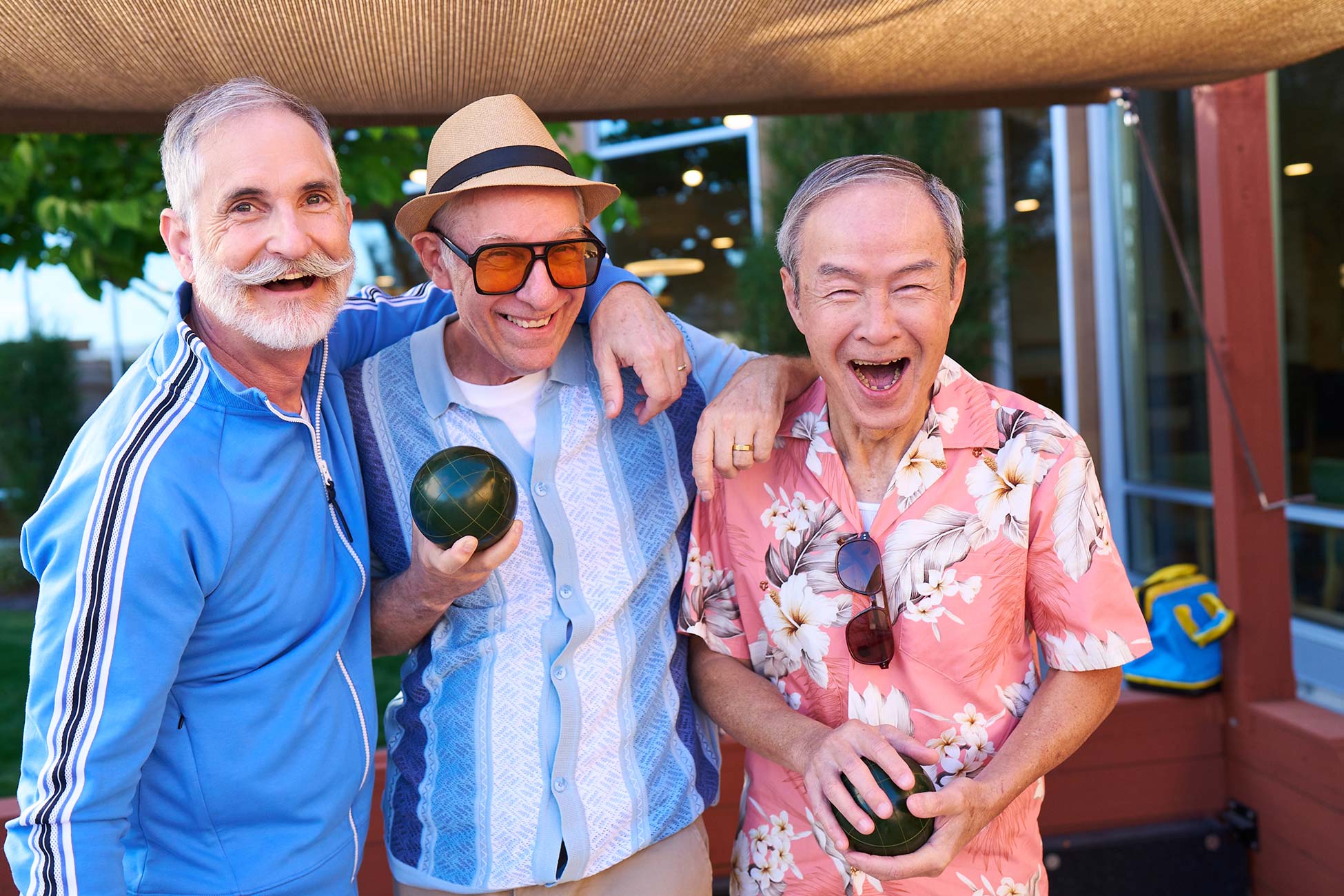 Three senior men playing bocce ball