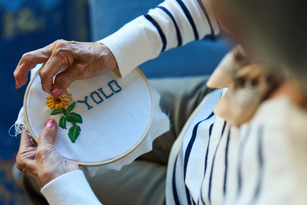 Woman embroidering YOLO