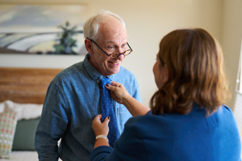 Caregiver Tying Necktie