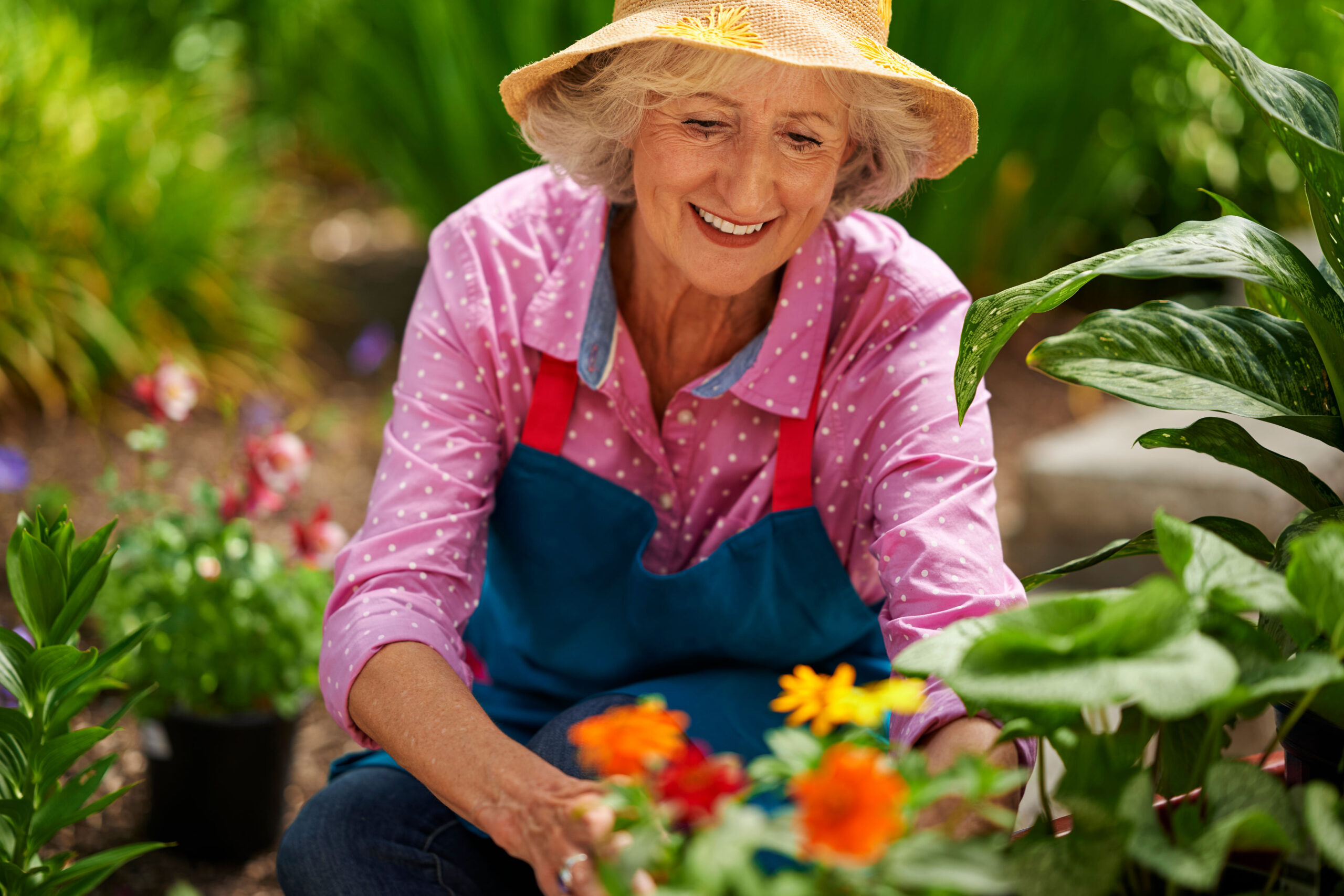 Older woman gardening with flowers