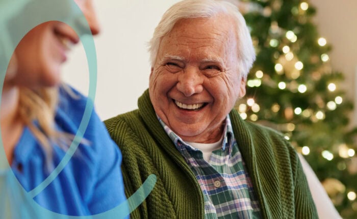 Man smiling at caregiver during holidays