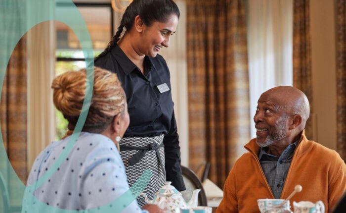Woman serving man and woman in dining room