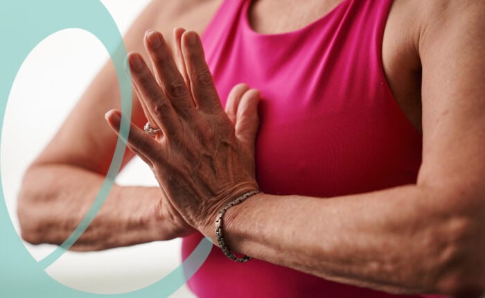 Woman with hands at heart center