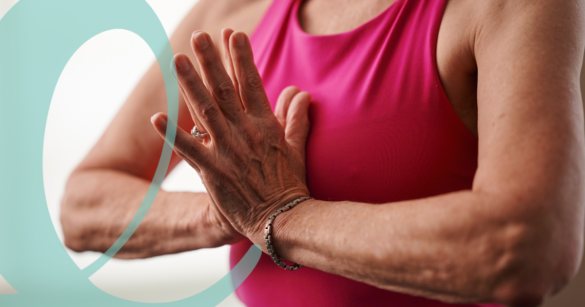 Woman with hands at heart center