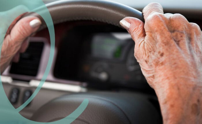 Senior driving hands on wheel