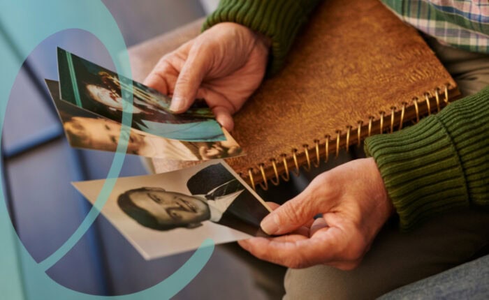 Man holding photos and reminiscing