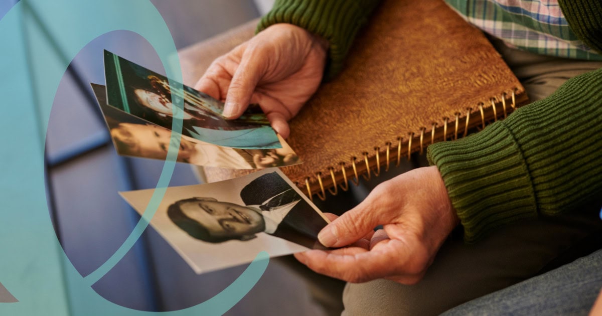 Man holding photos and reminiscing